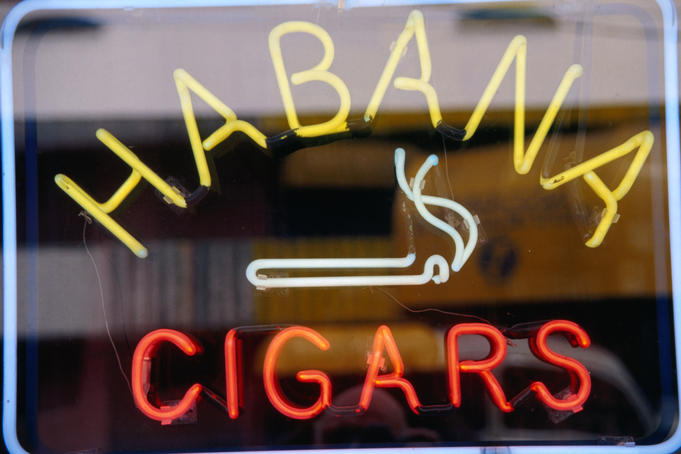 Sign for cigars on shop window.