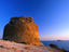 Golden light of a setting sun striking the ruins of a cliff-top watchtower at the Punta de l'Escaleta near Benidorm.