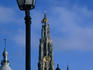 Lanterns by the riverside with the tower of Onze Lieve Vrouwekathedraal in background.