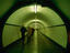People walking through St Anna Tunnel, a pedestrian tunnel under the Schelde river (built 1931-1933).
