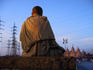 Statue of Swami Narayan and Hindu Temple with overhanging powerlines.