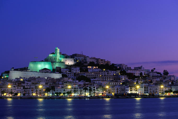 Night view across harbour of Elvissa and old walled town of D'Alt Vila.