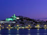 Night view across harbour of Elvissa and old walled town of D'Alt Vila.