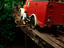 Man moving planks to help a fire truck cross a bridge.