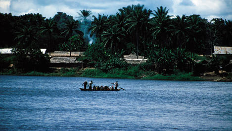 A crowded pirogue ferrying passengers across the Banalia River, Banalia.