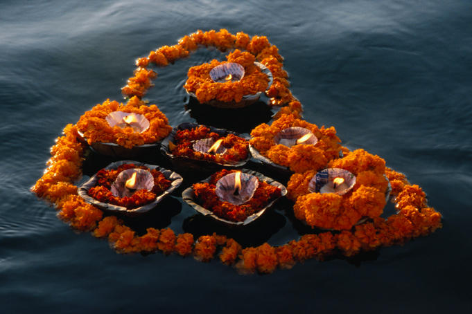 Garlands of flowers and floating candles are often seen on the river Ganges. They are given as offerings to Ganga, who is revered as a living goddess- Varanasi, Uttar Pradesh, India