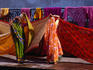 Women hanging saris up to dry after bathing in the sacred tank at Kalighat Hindu Temple, Calcutta.