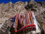 A camel travels past rocky Sinai cliffs.