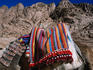 A camel travels past rocky Sinai cliffs.