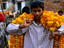 A young boy with enough marigolds to decorate the neighbourhood, his recent purchase will decorate his own home for the Diwali Festival held in November
