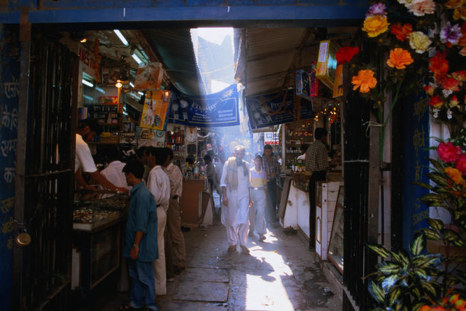A shaft of light illuminates a local in an alleyway in Chandni Chowk in Old Delhi