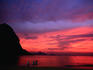 Locals fish under a glowing dawn sky by Rio's famous Pao de Acucar (Sugar Loaf).