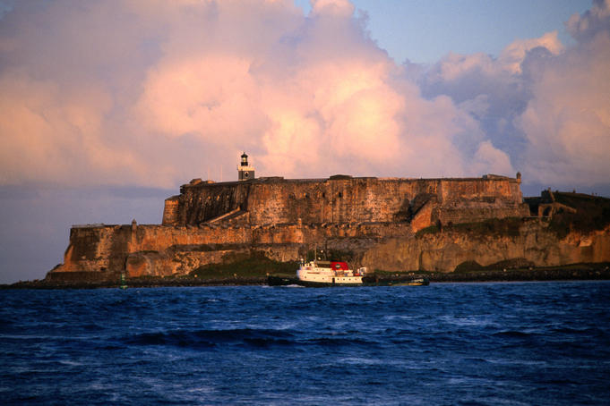 Tugboat passing Fort El Morro.