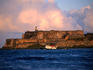 Tugboat passing Fort El Morro.