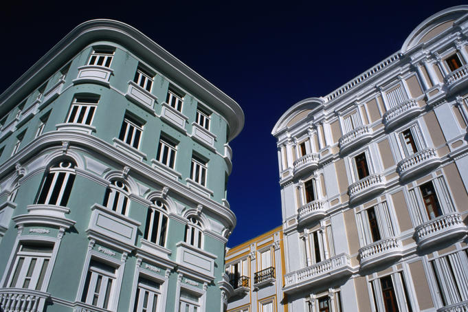 Balconied apartments overlook Plaza Portela at Calles Tecan and Tetuan in Old San Juan.