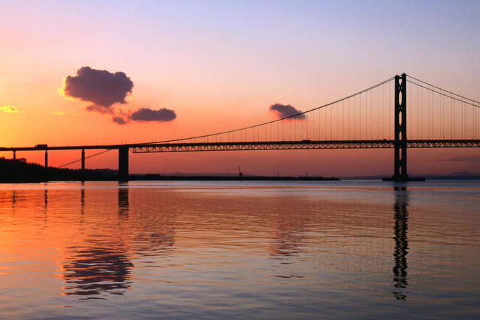 Forth Road Bridge reflected in the Firth of Forth at sunset, South Queensferry.