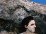 Woman covered in mud from volcanic mud pools.