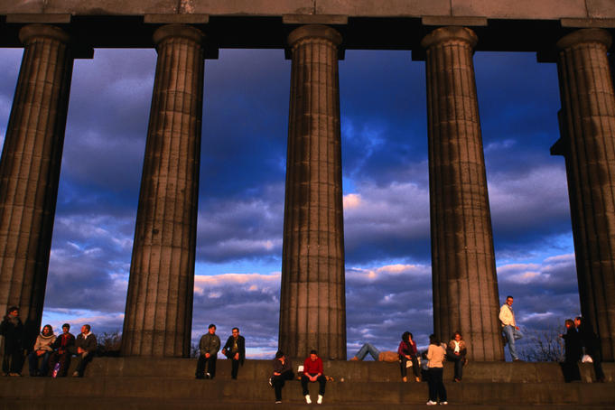 Parthenon National Monument on Calton Hill swarming with tourists in the evening sun, Edinburgh