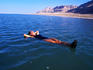 Woman floating in Dead Sea waters.