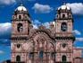 The upper half of the facade of La Compania, with clocks in the belltowers - Cuzco