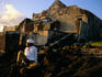 Boy sitting in front of mosque, Mitsamiouli, Comoros