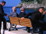 Old men enjoy a bench, a smoke and a chat on the waterfront.