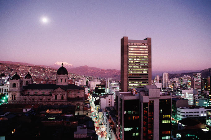 La Paz skyline with snow capped Mount Illimani at dusk. Bolivia's picturesque largest city is home to over half million inhabitants.