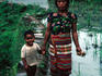 Environmental-portrait of mother and child in rice paddies.