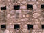 Pigeons nest in the small windows of an historical church in Cordoba.
