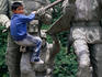 A young boy plays on a large statue honouring the soldiers of Argentina in downtown Cordoba.