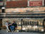 People sitting on bench outside Victoria and Albert Museum.