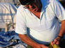 Fisherman repairing his net.