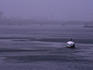 A boat makes its way up the River Nile, while central Cairo is covered with a mixture of sand and smog
