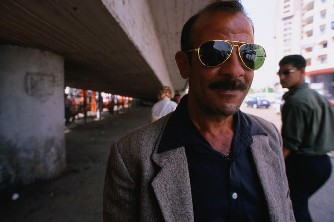 Egyptian man wearing sunglasses, Central Cairo bus stop