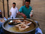 Making pancakes on A-Muizz li-Din in Islamic Cairo, the pancakes are cooked on a hotplate, sprinkled with icing sugar, wrapped and then eaten as take-away