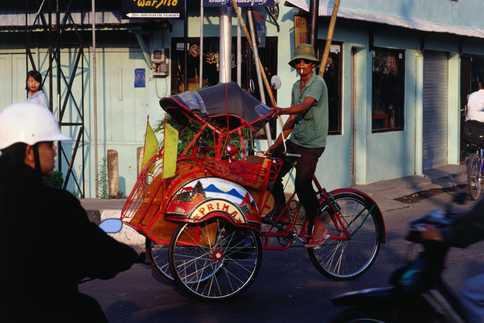 Becak on city street.