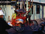 Becak on city street.