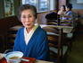 Elderly lady, in the traditional Japanese kimono, sits down to a bowl of soba noodles at Matsuba-ya soba restaurant in Kyoto- Japan