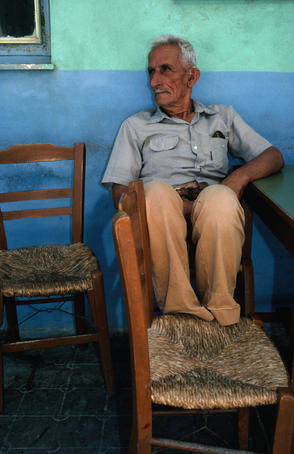 Local watching the world go by sitting in a taverna in Crete.