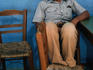 Local watching the world go by sitting in a taverna in Crete.