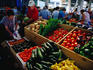 Shopping at Farmer's Market. Barrels of squash.