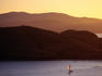 Boat sailing near island.