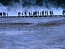 Hikers walking along a boardwalk at Midway Geyser Basin.