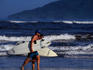 A couple of surfers carrying their boards on the beach at Tamarindo on the Nicoya Peninsula.