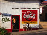 Exterior of corner store in afternoon light.