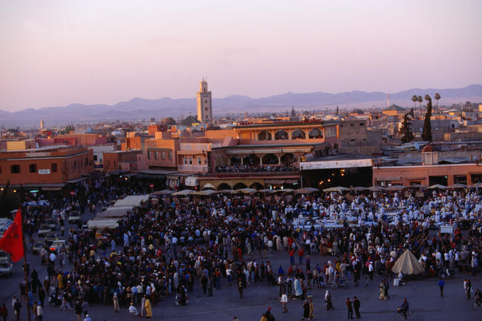 Djemmaa el-Fna, the huge square in the medina of Marrakesh, crammed with a myriad of stalls, performers and spectators.