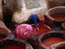 A man works at the mud brick leather tannery wells in the Fes medina. Fassi leather produced in Fes according to medieval practices is among the finest in the world.