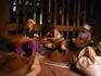 Factory workers grinding coffee in a river powered pounder.