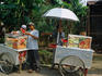 A fruit vendor prepares fruit for a delicious serve of rujak.