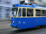 One of Zagreb's blue trams trundling along a city street.